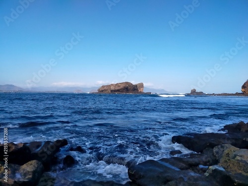 Dramatic Rocky Coastline with Blue Ocean and Clear Sky