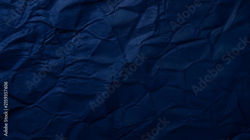 Dark blue crumpled paper texture surface background with creased folds and subtle shadows crumpled background wrinkled abstract