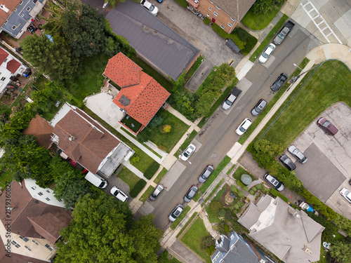 Aerial view residential neighborhood with homes and cars