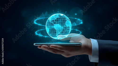 A futuristic hand holding a smartphone displaying a holographic globe symbolizing global technology and connectivity