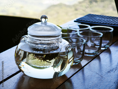 Transparent Teapot and Empty Glasses on a Rustic Wood Table
