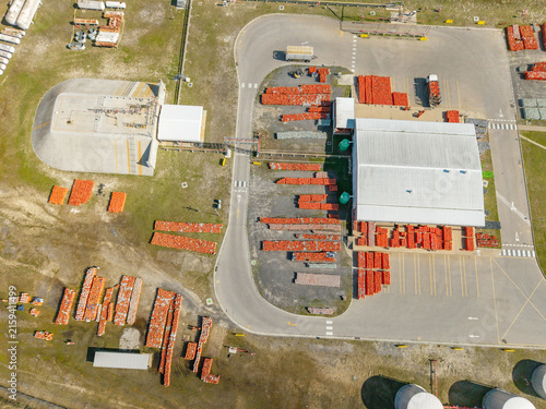 Aerial view of Kleinvlei industrial facility with storage warehouses, numerous orange containers, and large tanks in Cape Town, Western Cape, South Africa.