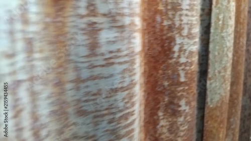 Rusted corrugated metal sheet surface texture closeup moving panning shot