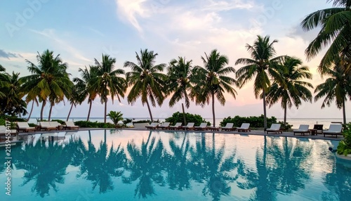 Luxury infinity pool with palm tree reflections.