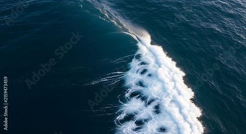 Aerial perspective of powerful deep blue ocean wave cresting