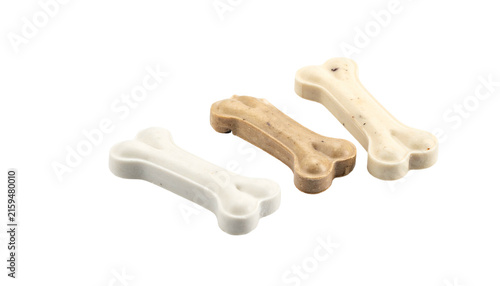 Plakat Three bone-shaped dog treats, varying in color, on a black surface