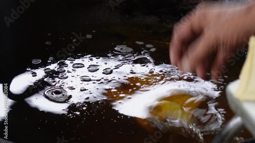 Crispy samosas dropping into sizzling hot oil