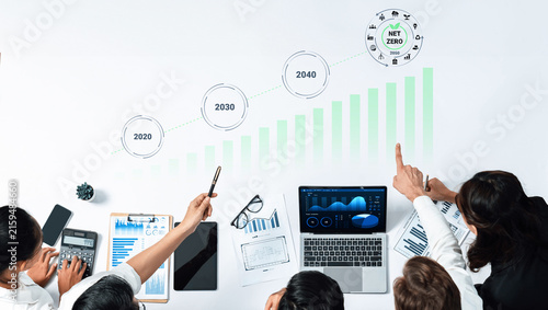 Konstfotografi Professionals engage in data analysis to assess strategies for achieving net zero by 2040, utilizing charts and technology in a collaborative office environment