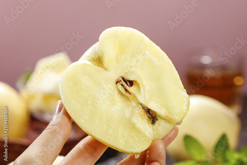 Fresh Golden Fuji Apple Slice in Hand - Healthy Organic Fruit Close-up