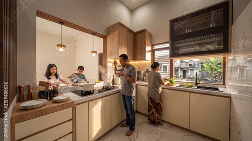 Family cooking together in a modern minimalist kitchen interior with warm lighting