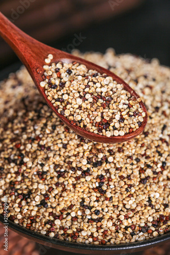 Tricolor Quinoa Grains in Wooden Spoon - Healthy Superfood Cereal Mix for Nutritious Cooking and Meal Replacement