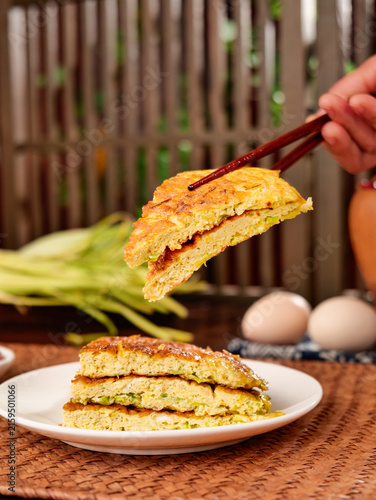 Bild auf Leinwand Fresh Leek Omelette with Chopsticks - Tantalizing Asian-Style Egg Dish on Rustic