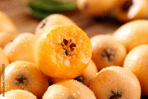 Quadro su tela Fresh Yunnan Loquat Fruits Close-up - Sweet Orange Asian Fruit Display