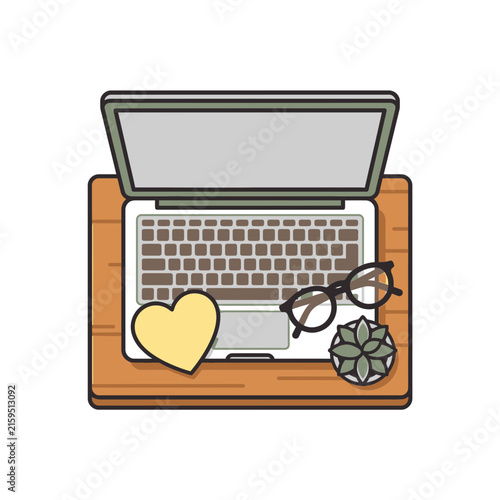 Laptop desk setup with heart sticker and glasses.