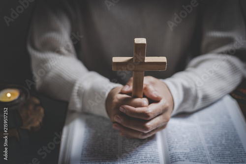 Konstfotografi A woman kneeling in prayer with a cross in a room, symbolizing Christian faith, worship, hope, spiritual guidance, and peace