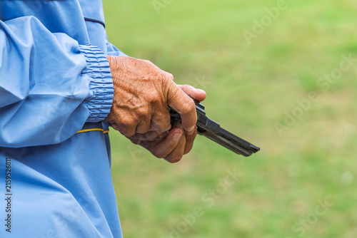 Obraz na plátně Referee checking starting pistol revolver for sports competition
