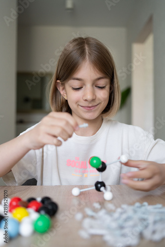 girl making molecular model learning chemistry science, home education. STEM 