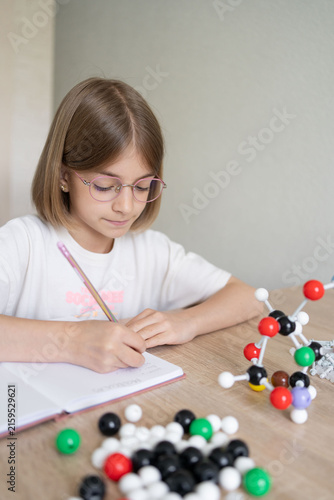 science and child with atom model for project, discovery or assignment. STEM education. Elementary science student using plastic atom model educational toy. 