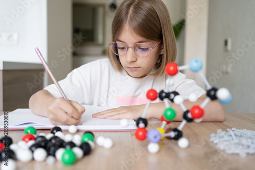 science and child with atom model for project, discovery or assignment. STEM education. Elementary science student using plastic atom model educational toy. 