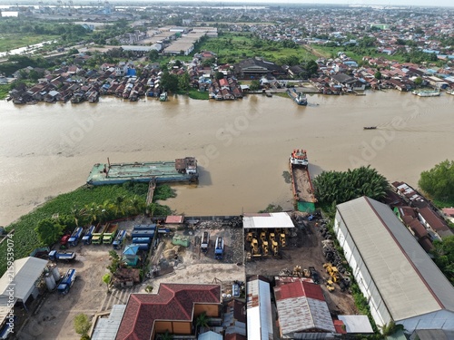 Принти на полотні Aerial view of oil tankers and heavy equipment ferry boats parked on the riverba