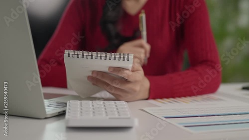 Professional businesswoman taking notes at her desk