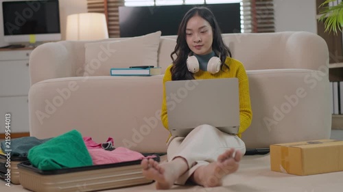 Young asian woman booking hotel online before traveling
