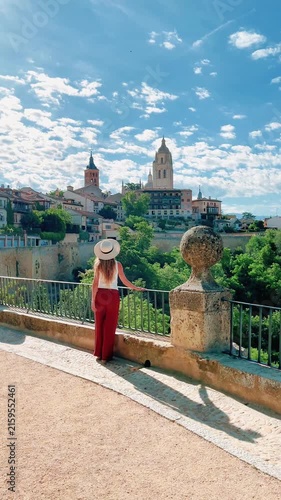 woman admiring view of segovia cathedral and old town in spain