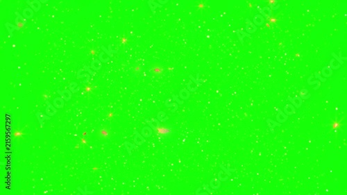 Golden dust particles and glowing sparkles float across a solid green screen background for visual effects editing.