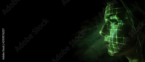 Close up profile of young woman face with glowing green laser grid matrix projection, AI biometric facial recognition system and cyber security access technology concept with large copy space