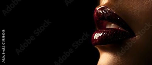 Macro close up profile of beautiful female lips with glossy dark maroon lipstick and gold glitter sparkles, premium cosmetics makeup and luxury beauty branding concept with large copy space