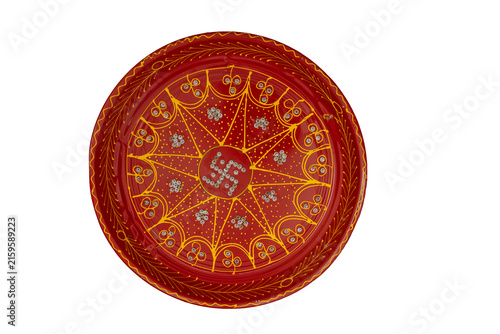 Red decorative thali displaying a hindu swastika symbol and traditional embellishments
