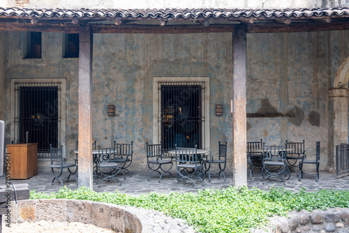 Tequila, Mexico - March 29 2026: Capturing the historic charm of a traditional Mexican patio cafe in Tequila town center. Rustic ambiance with old stone walls, barred windows, and quaint outdoor
