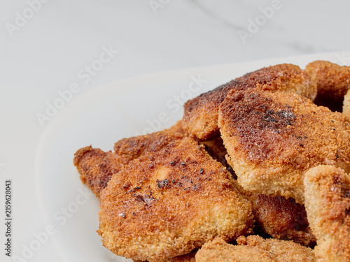 Fried soy cutlets on a white plate, close-up.