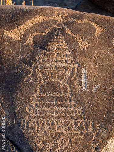 Closeup vertical view of ancient petroglyph of buddhist stupa on rock on historic silk road in Indus river valley, Chilas, Gilgit Baltistan, Pakistan