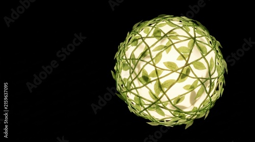 Decorative lamp with green leaves design illuminating a dark environment