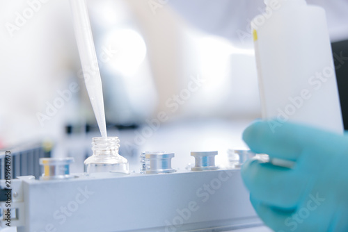 Obraz na płótnie Laboratory pipetting closeup filling vial for biochemical analysis for clinical