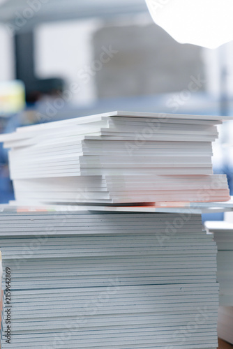 Quadro su tela Vertical stack of paper reams in printing facility for production background
