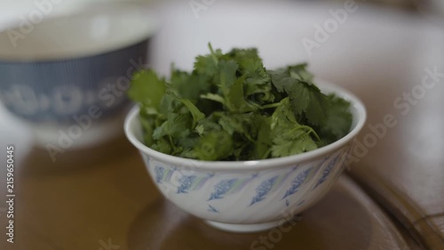 Fresh Coriander In A Bowl On Wooden Table
