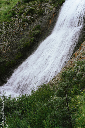 фотографія Powerful waterfall cascading down a rocky mountainside