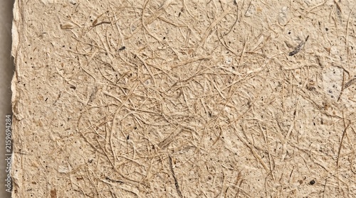Close-up recycled kraft paper texture with natural fibers and subtle creases for eco-friendly design projects