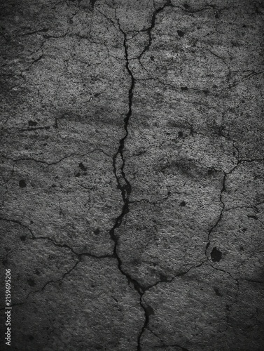 Fotografie cracked concrete surface in weathered urban environment with top-down perspective showing detailed texture and gray-black coloration for architectural and construction design resources