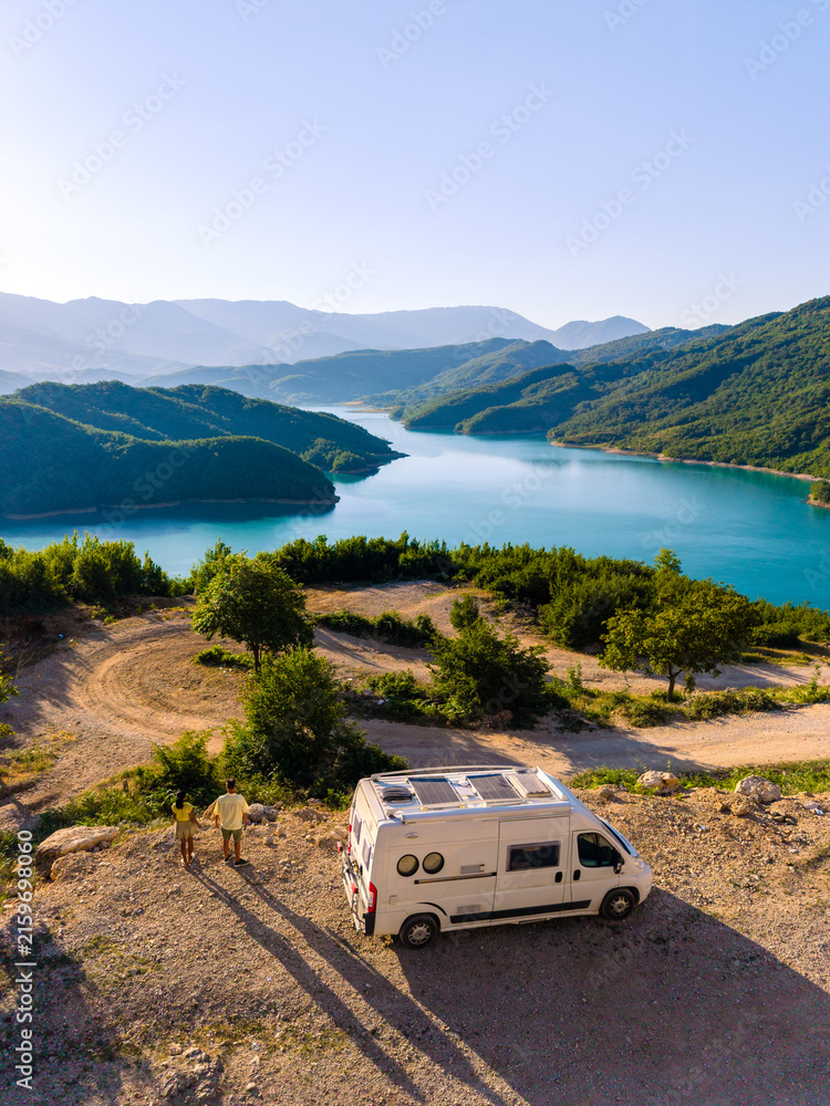 Fototapeta premium Breathtaking view over Bovilla Reservoir in Albania with a camper van setting