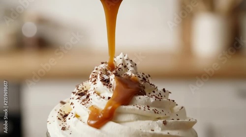 Pouring caramel sauce over whipped cream