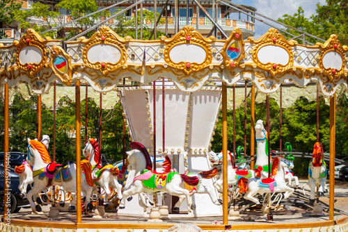 Fotografía Horizontal eye level wide shot of a vintage ornate carousel with colorful horses