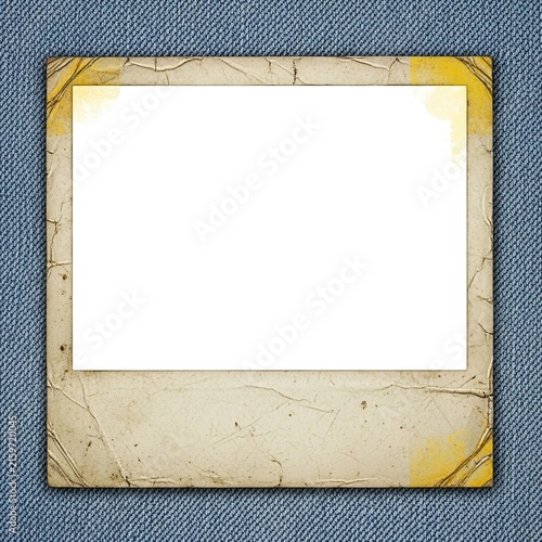 Vintage aged Polaroid style photo frame on blue denim background.