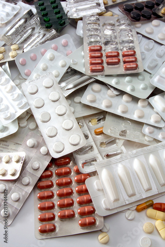 Several tablets and capsules in blister packs, close-up
