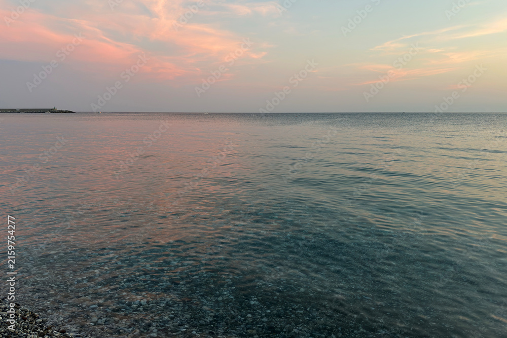Fototapeta premium Beautiful Seascape with Pink Clouds Reflected on Water. View from Chiavari Village during a Summer Sunset. Genoa Province, Italy