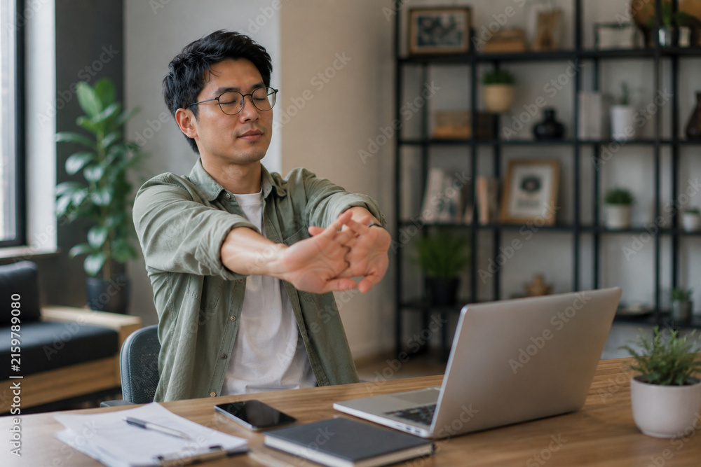 Fototapeta premium AI generated freelancer stretching hands after long hours of typing at laptop showing workplace wellness fatigue prevention healthy breaks remote work routine
