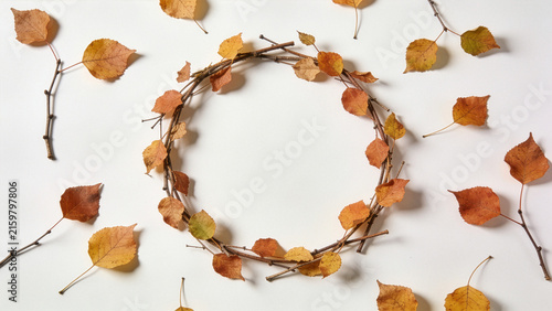 Delicate circular autumn leaf wreath flat lay with empty center for text