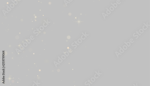 Fotografie Scattered golden star-shaped sparkles and bokeh lights on a black background on